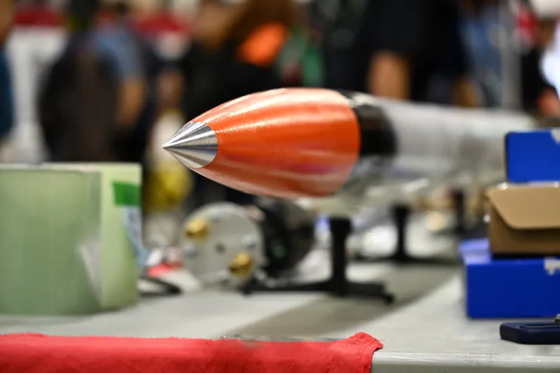 Orange nose cone and machined tip at the competition exhibition