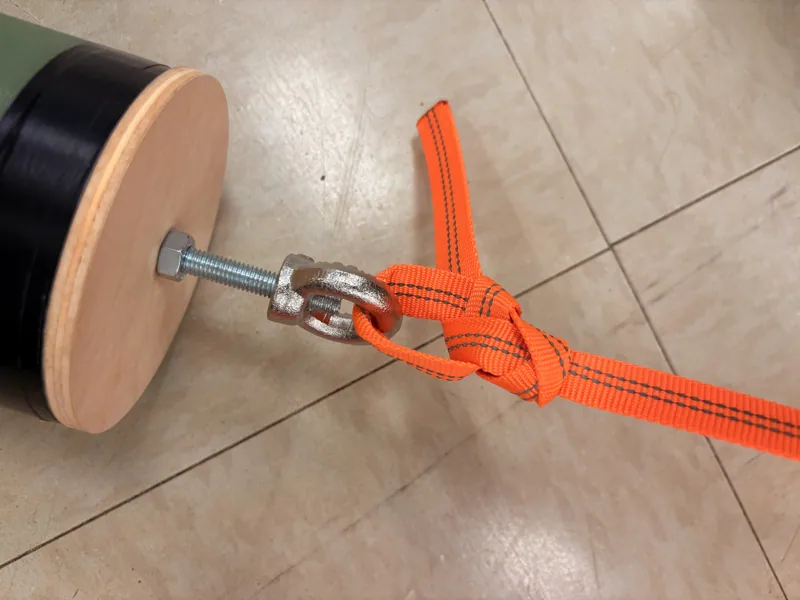 Orange recovery harness attached to a bulkhead fitting